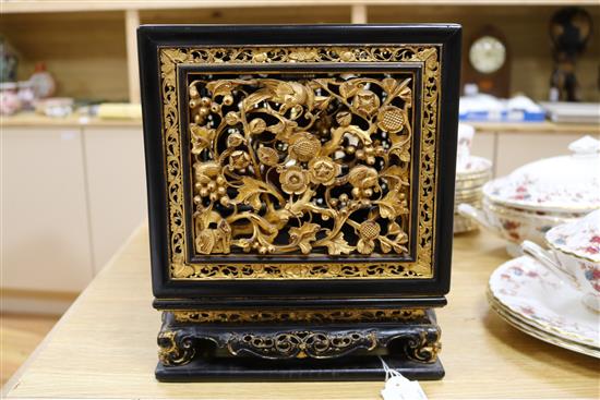 A late 19th/early 20th century Chinese giltwood and black lacquer incense stand